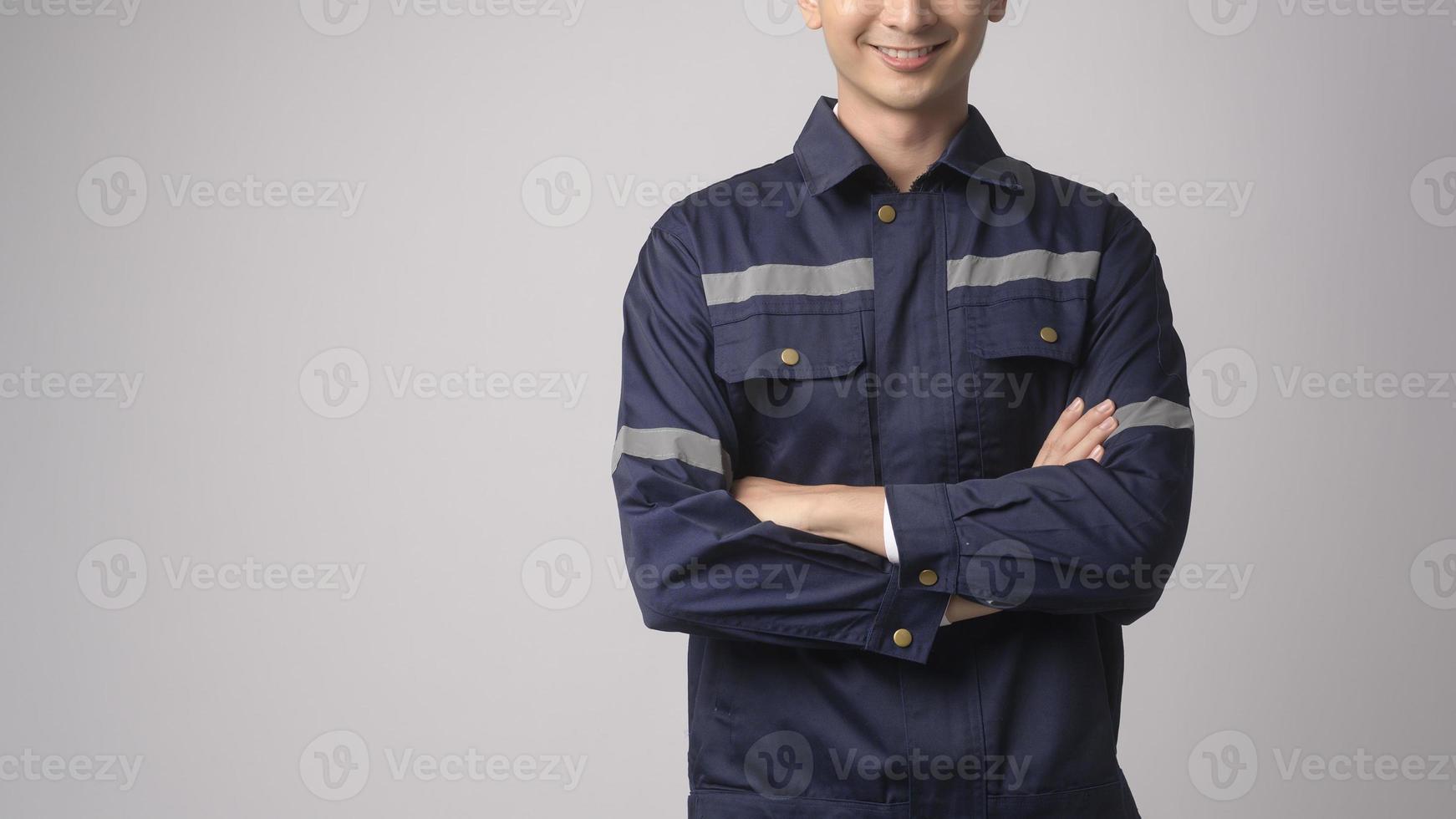 Portrait of male engineer wearing a protective helmet over white background studio. photo