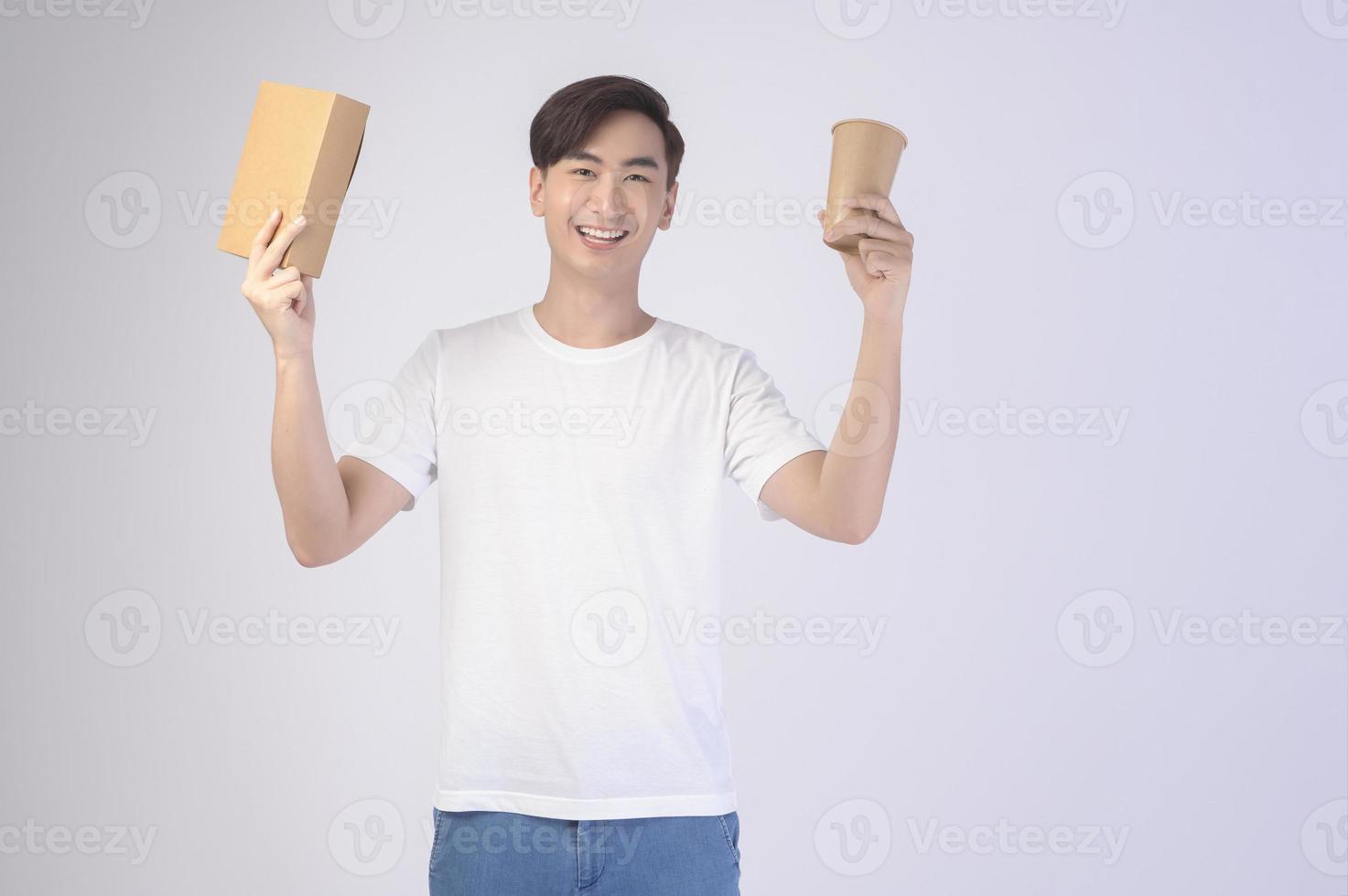 Young asian man holding paper cup and paper box over white background, Save earth concept photo