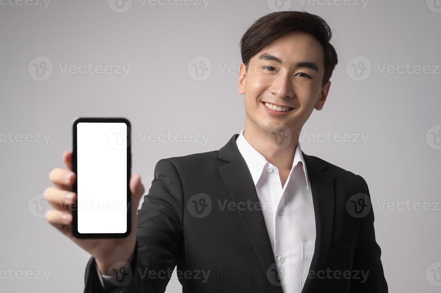Young businessman wearing  suit over white background studio photo