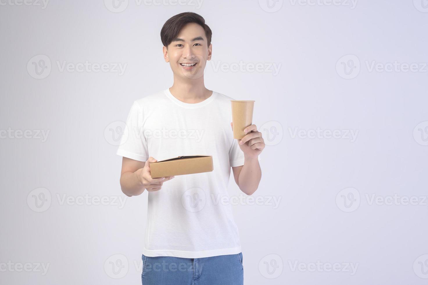 Young asian man holding paper cup and paper box over white background, Save earth concept photo