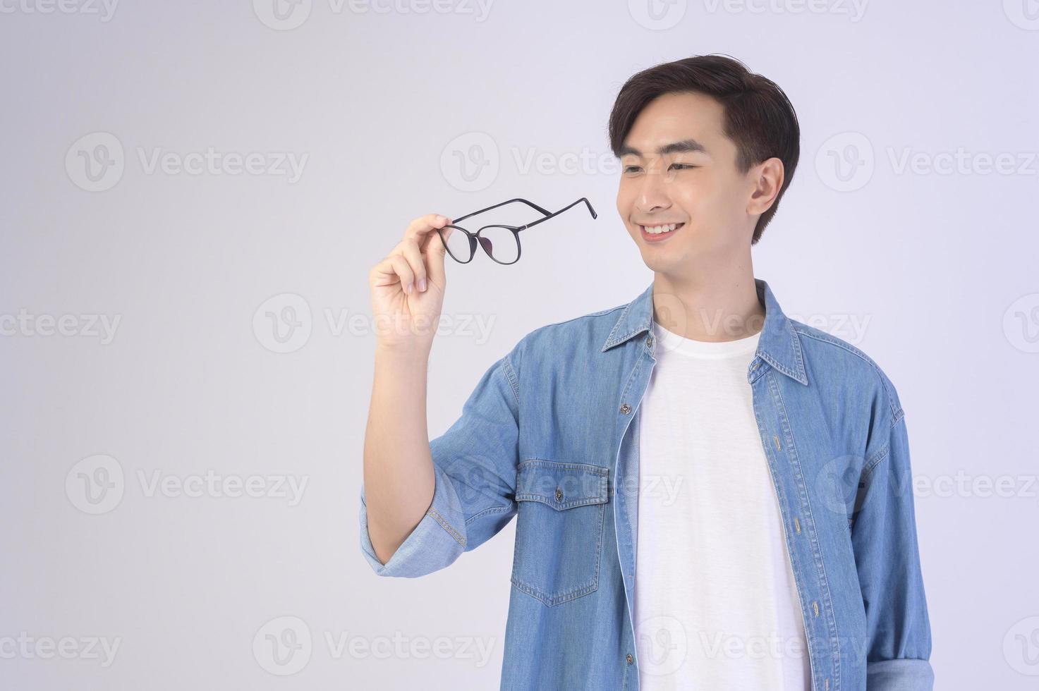 Portrait of asian man wearing glasses over white background studio, eyecare concept. photo