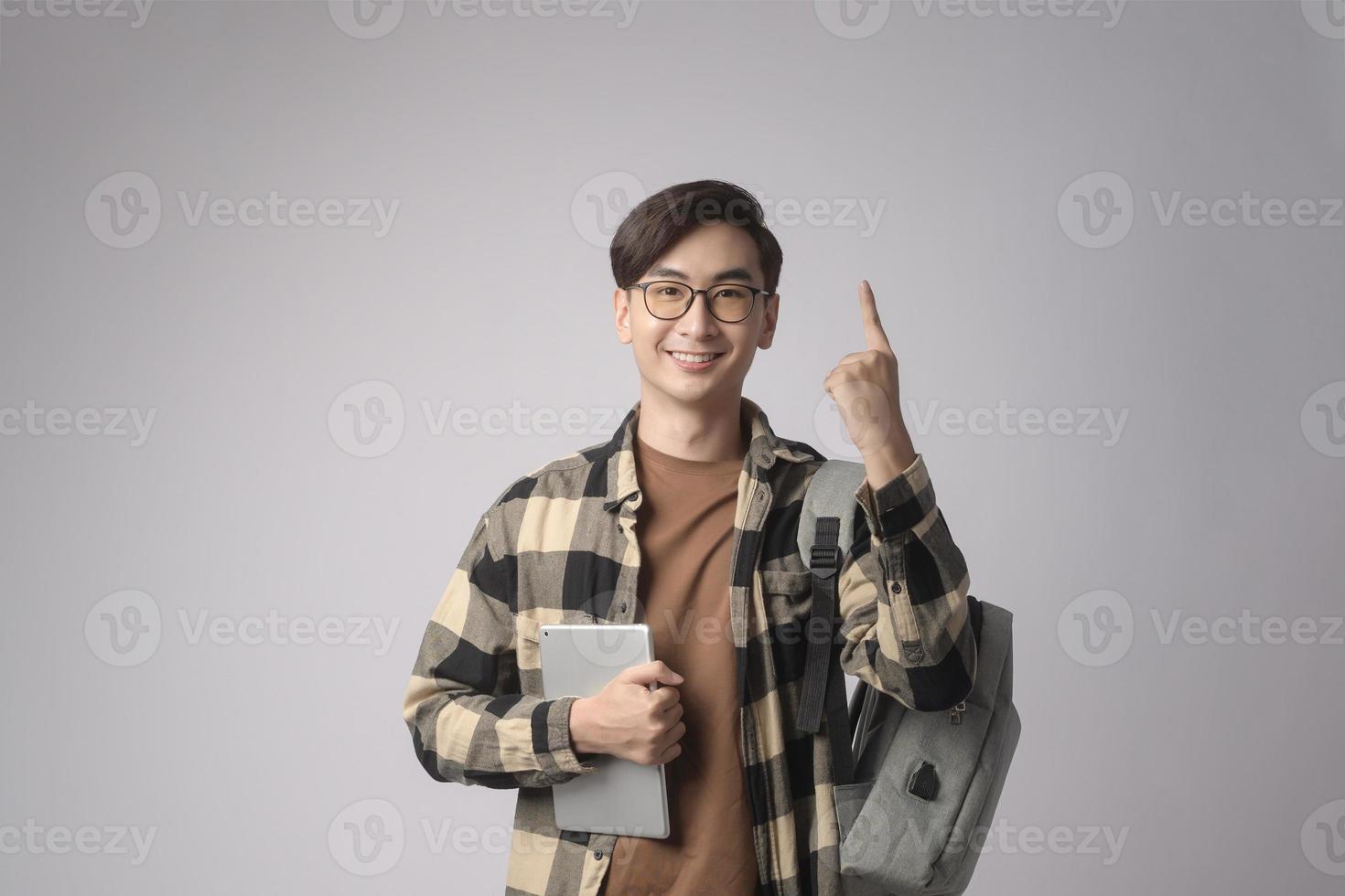 Portrait of an Asian university student over white background studio, education concept. photo