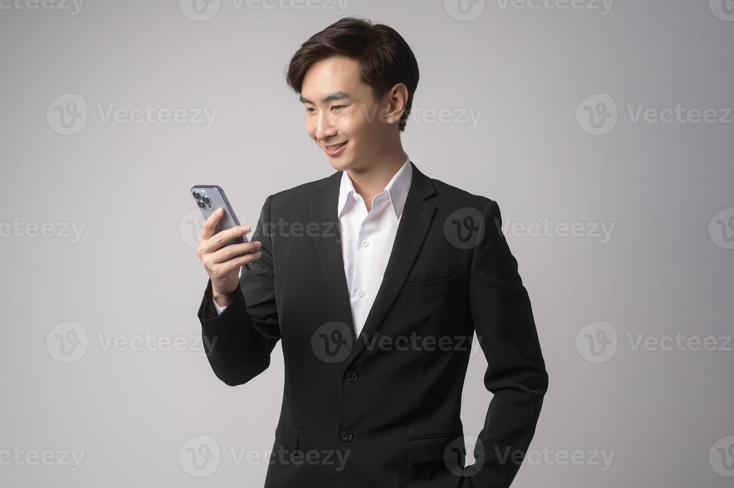Young businessman wearing  suit over white background studio photo
