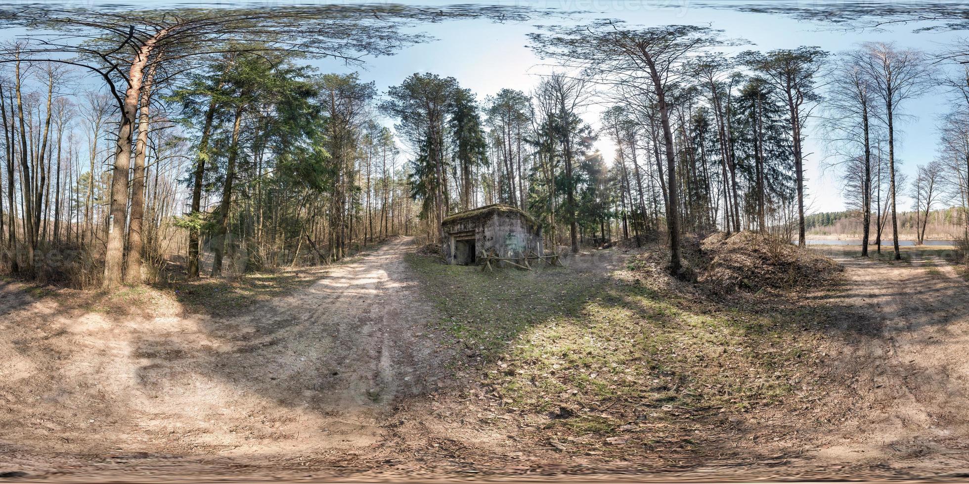 full seamless spherical hdri panorama 360 degrees angle view near stone abandoned ruined military bunker building in pine forest in equirectangular projection, ready AR VR virtual reality content photo