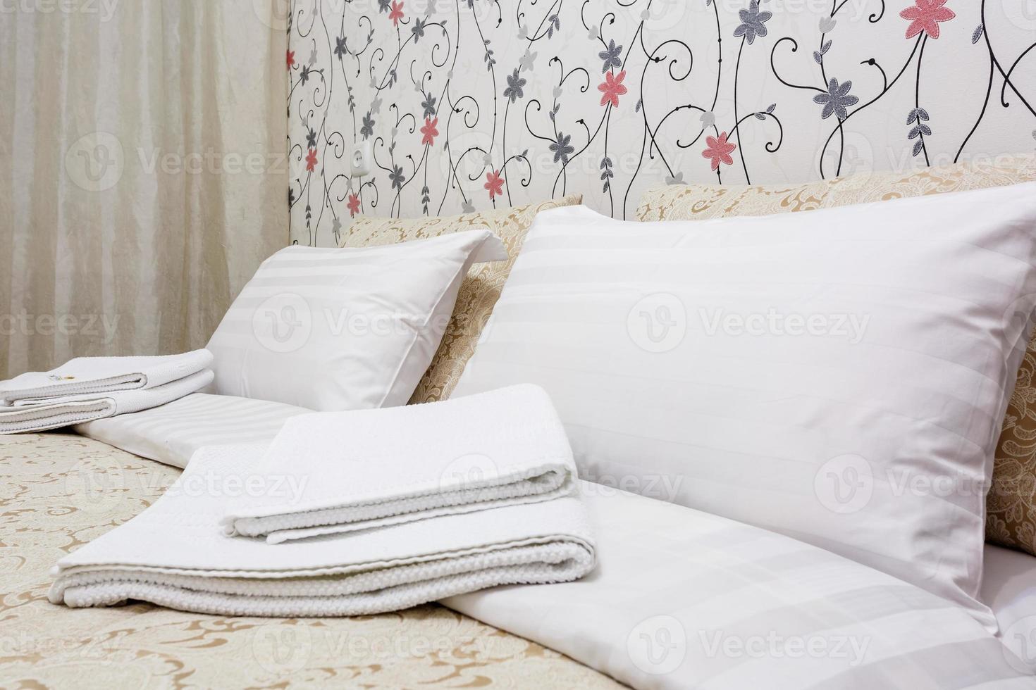 Double bed with pillows in interior of the modern bedroom in loft flat in light color style of expensive apartments photo