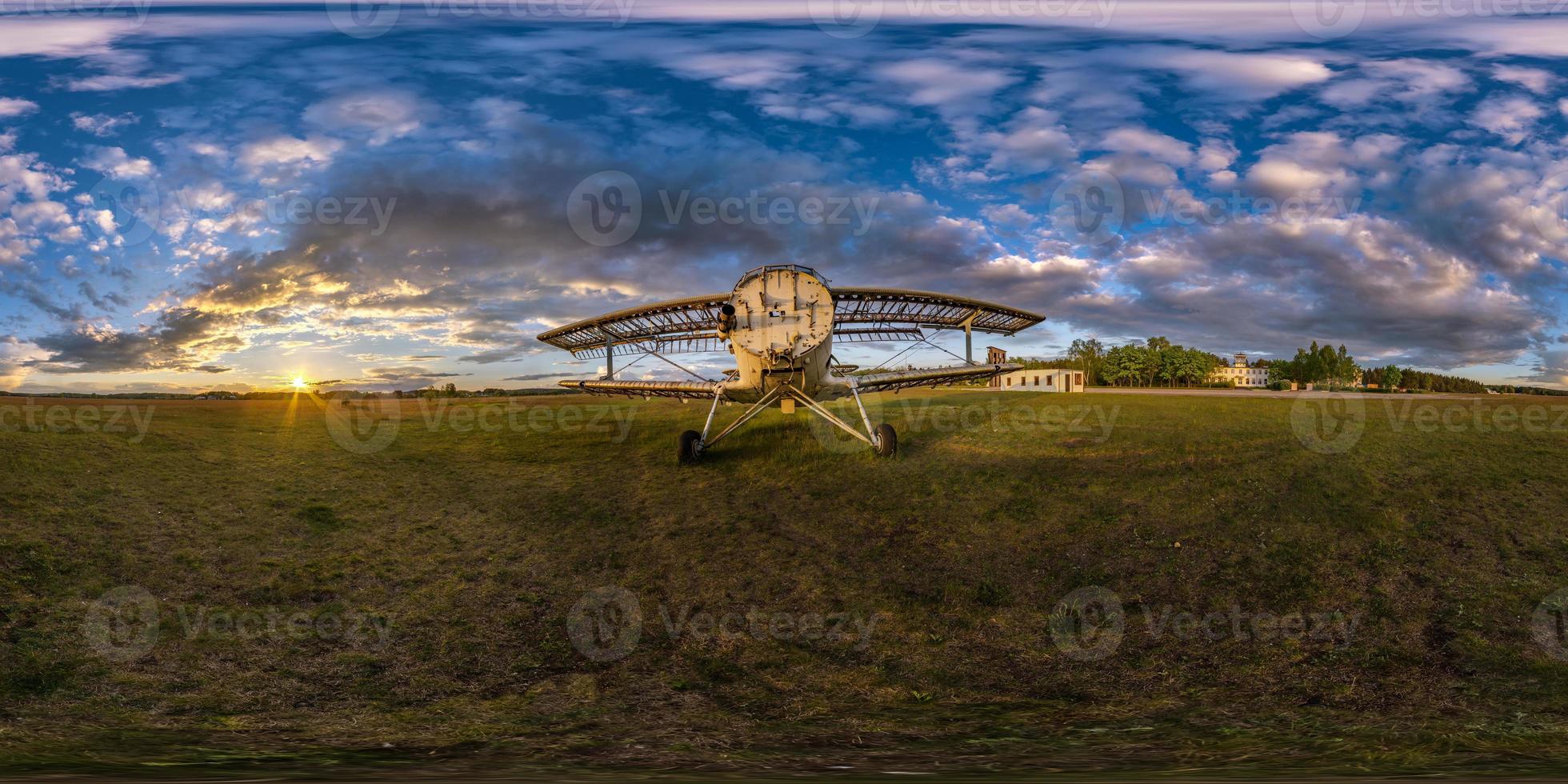 full seamless spherical hdri panorama 360 degrees angle view among fields near old airplane in summer evening sunset with awesome clouds in equirectangular projection, ready for VR AR virtual reality photo