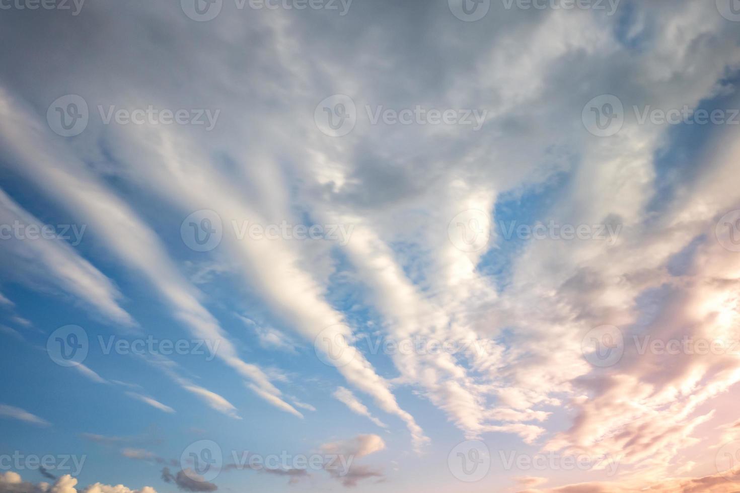 Blue sky background with tiny curly striped clouds in the evening. Clearing day and Good windy weather photo