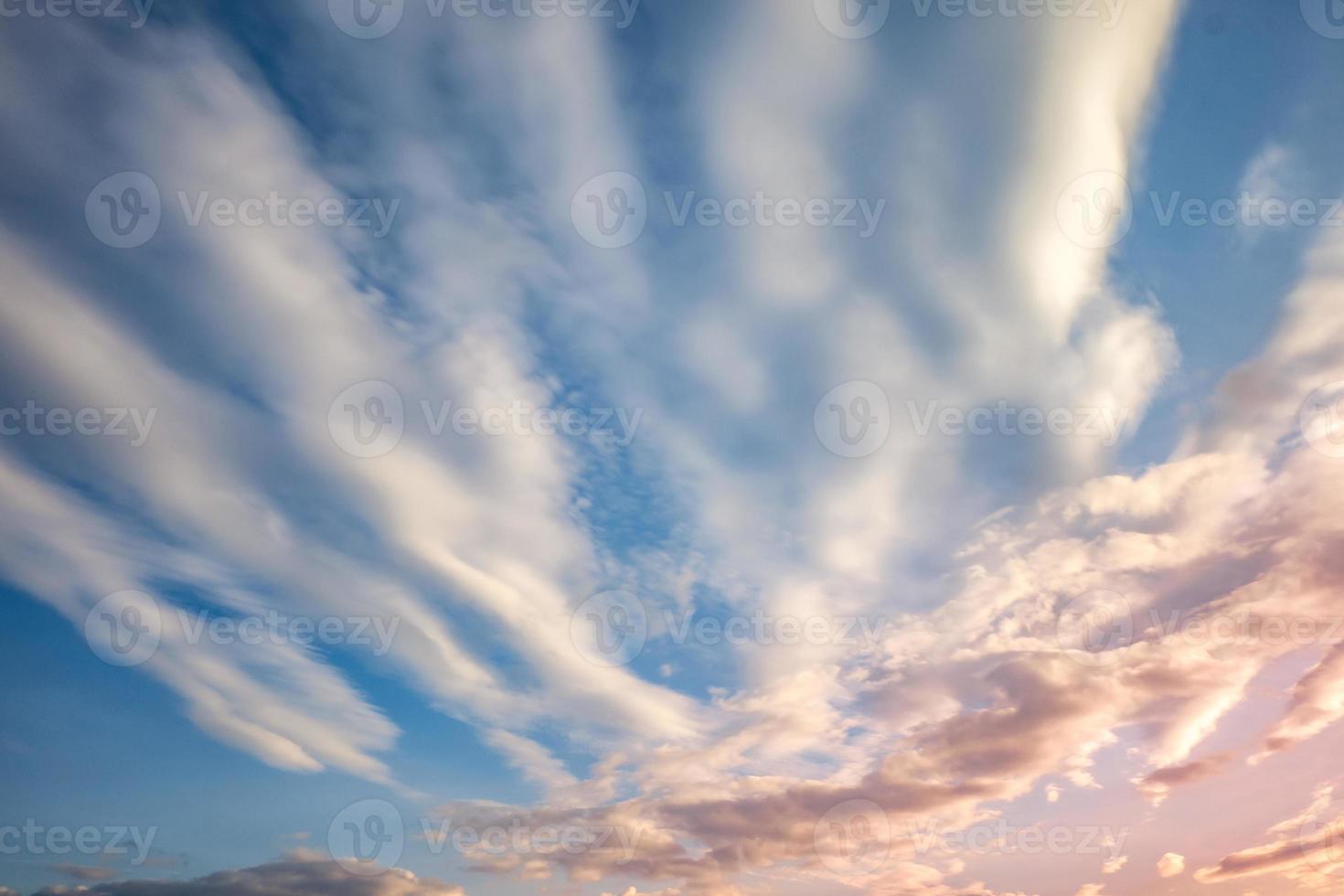 Blue sky background with tiny curly striped clouds in the evening. Clearing day and Good windy weather photo