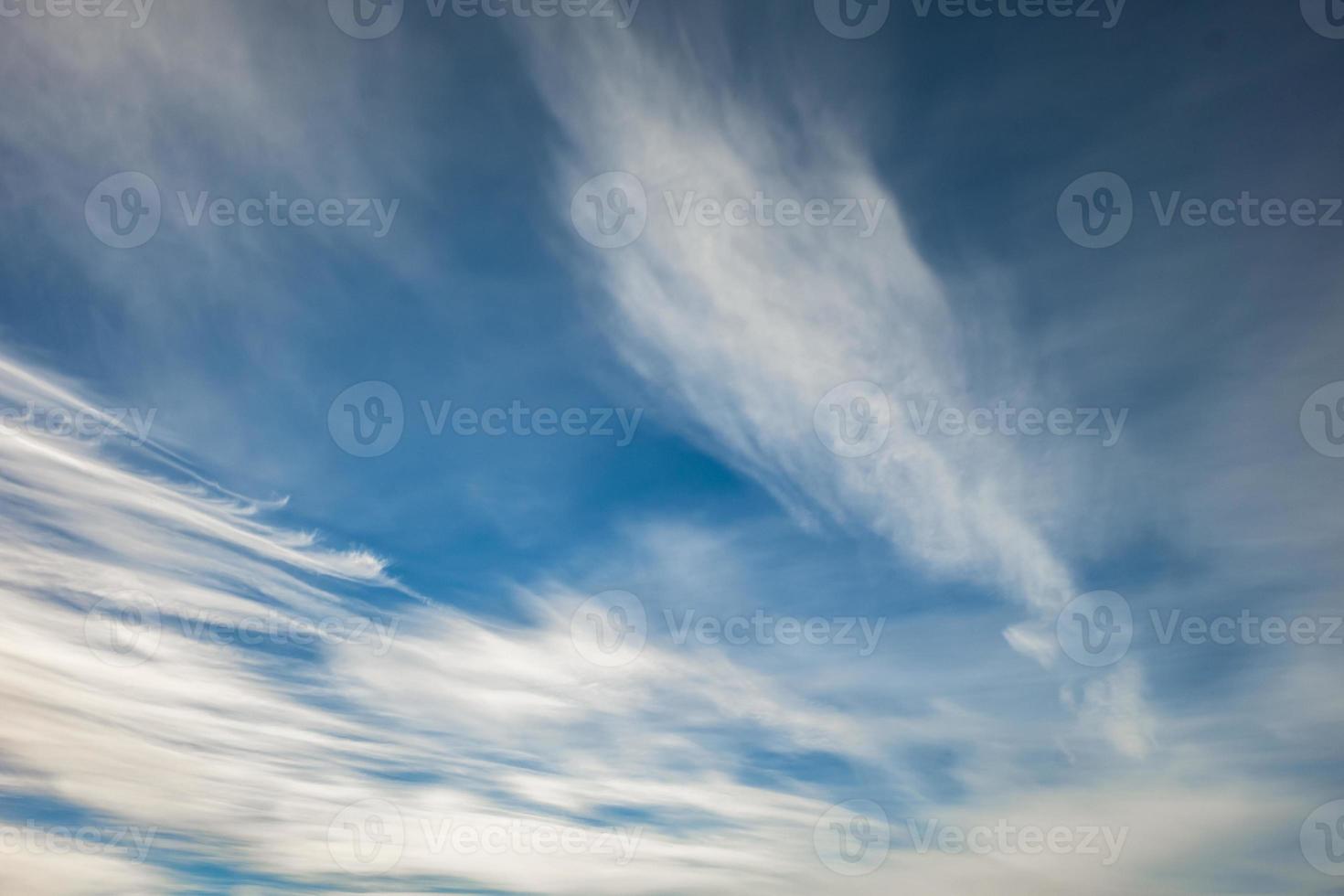 Blue sky background with tiny stratus cirrus striped clouds. Clearing day and Good windy weather photo