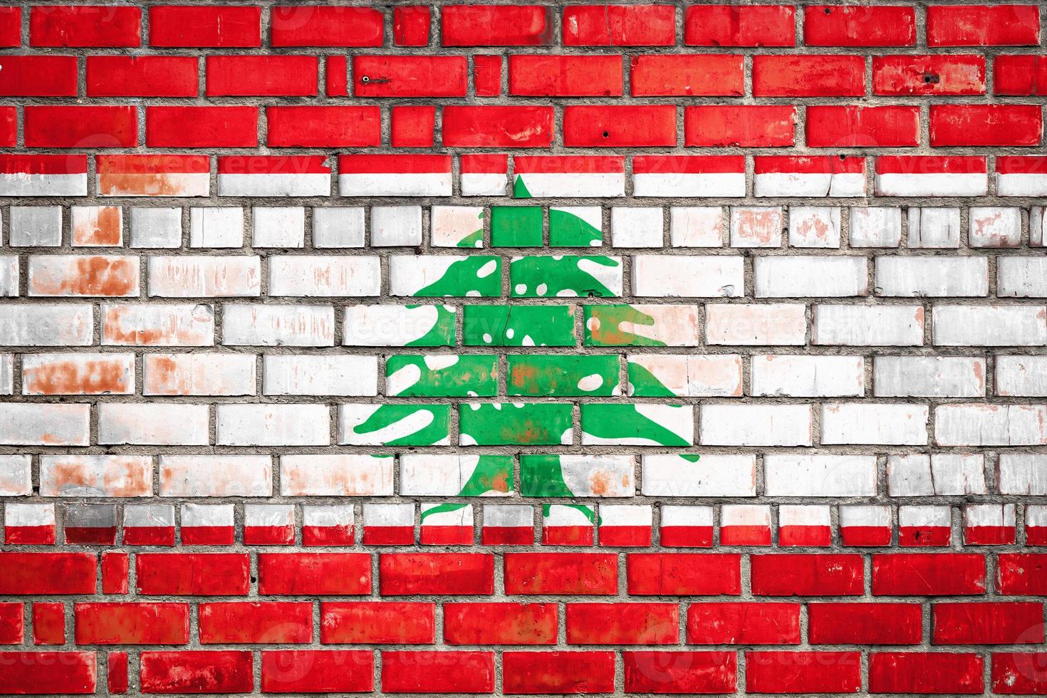 National  flag of the  Lebanon   on a grunge brick background. photo