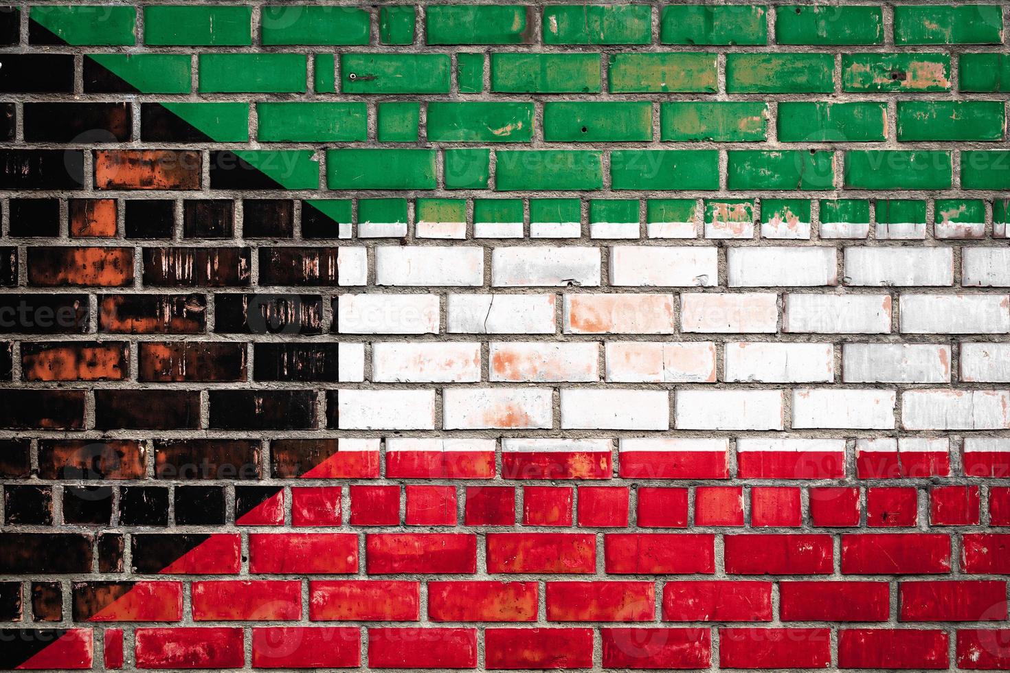 National  flag of the   Kuwait  on a grunge brick background. photo