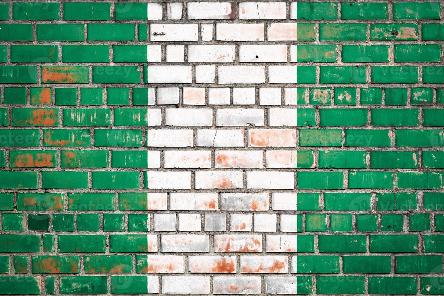 National  flag of the Nigeria  on a grunge brick background. photo