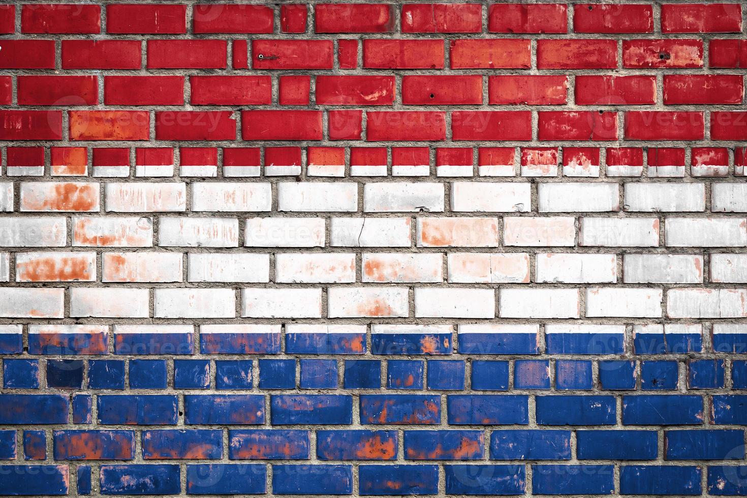 National  flag of the Netherlands  on a grunge brick background. photo