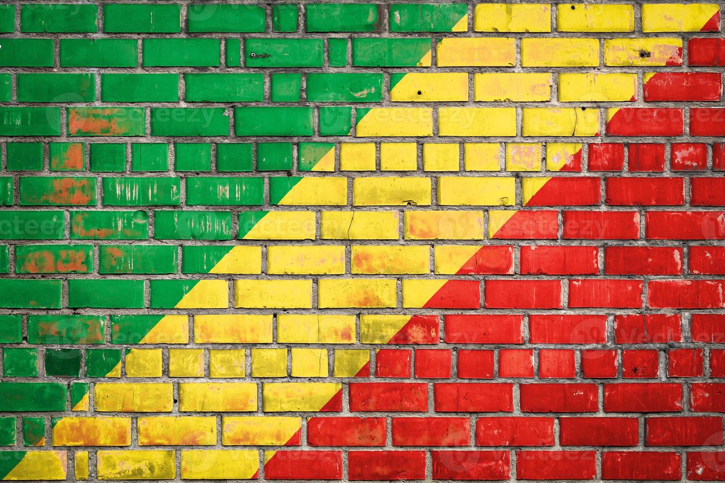 National  flag of the Republic of the Congo on a grunge brick background. photo