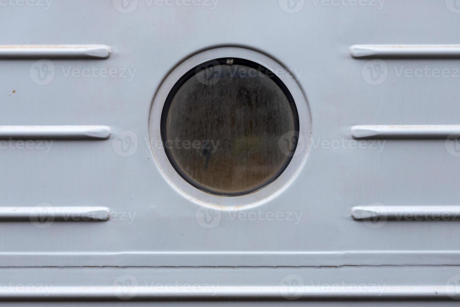 Close-up of a round window  in old stoun  house photo