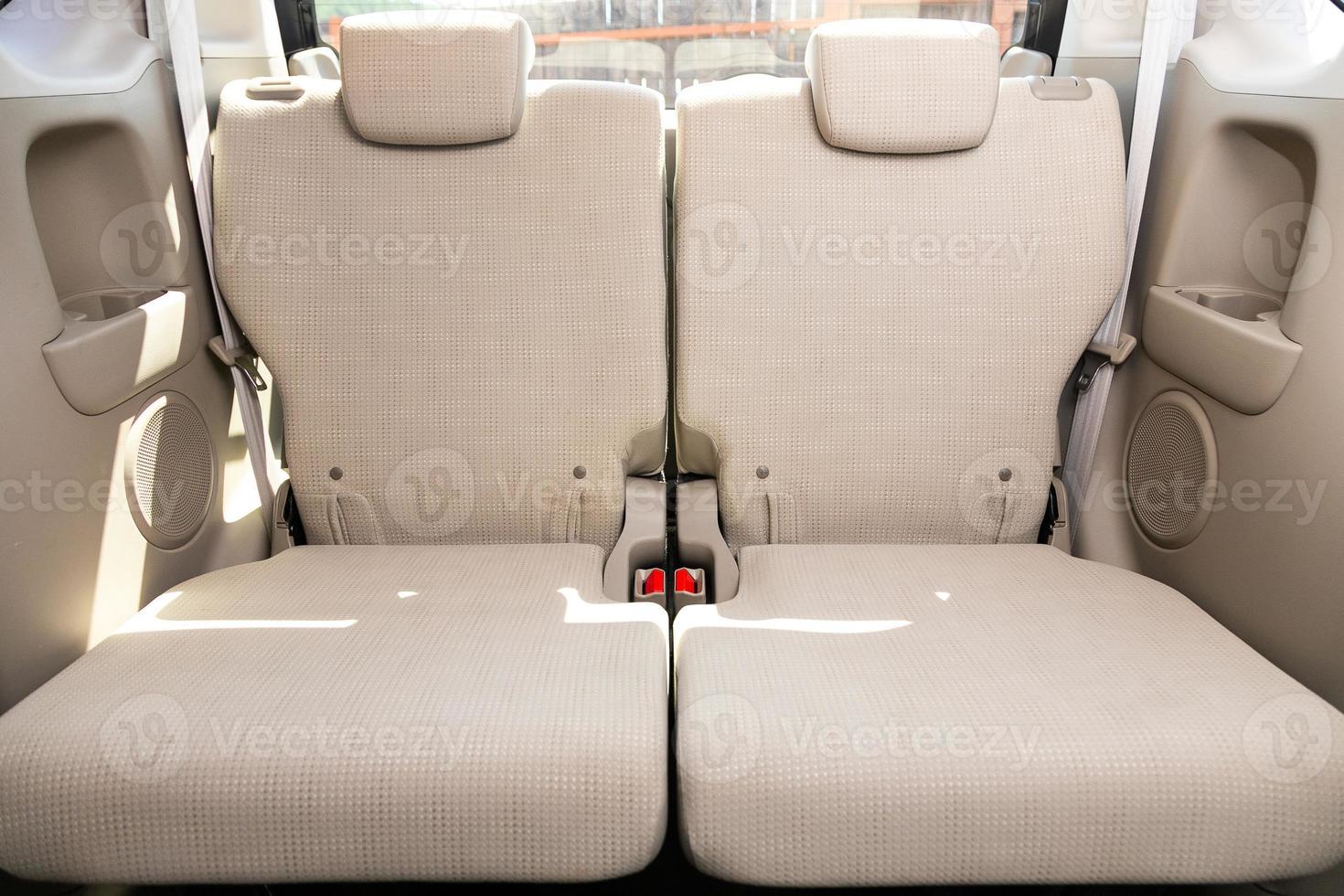 Beige  interior design, car passenger and driver seats with seats belt. photo