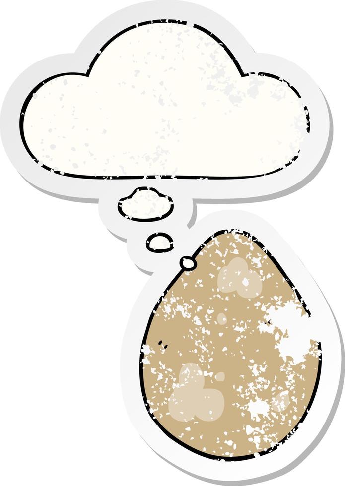 cartoon egg and thought bubble as a distressed worn sticker vector