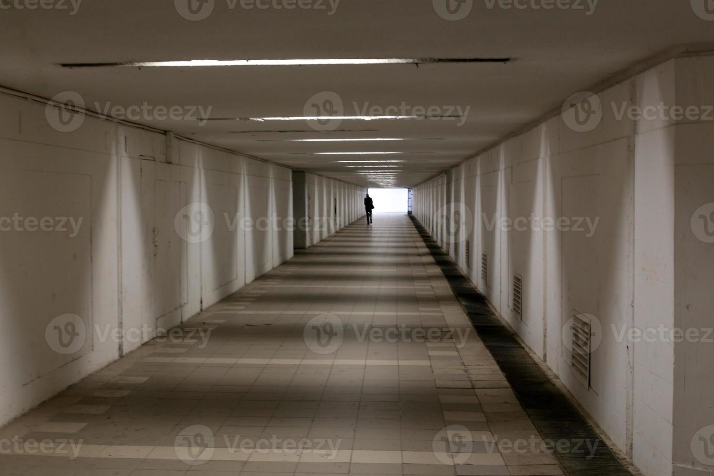 A narrow and long corridor on the lower floor of the building. photo