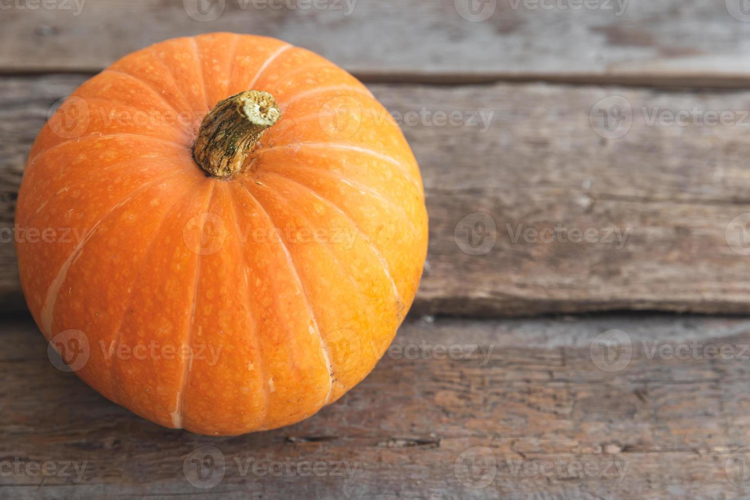 Autumnal Background. Natural autumn fall view pumpkin on wooden background. Inspirational october or september wallpaper. Change of seasons ripe organic food concept. Halloween party Thanksgiving day photo