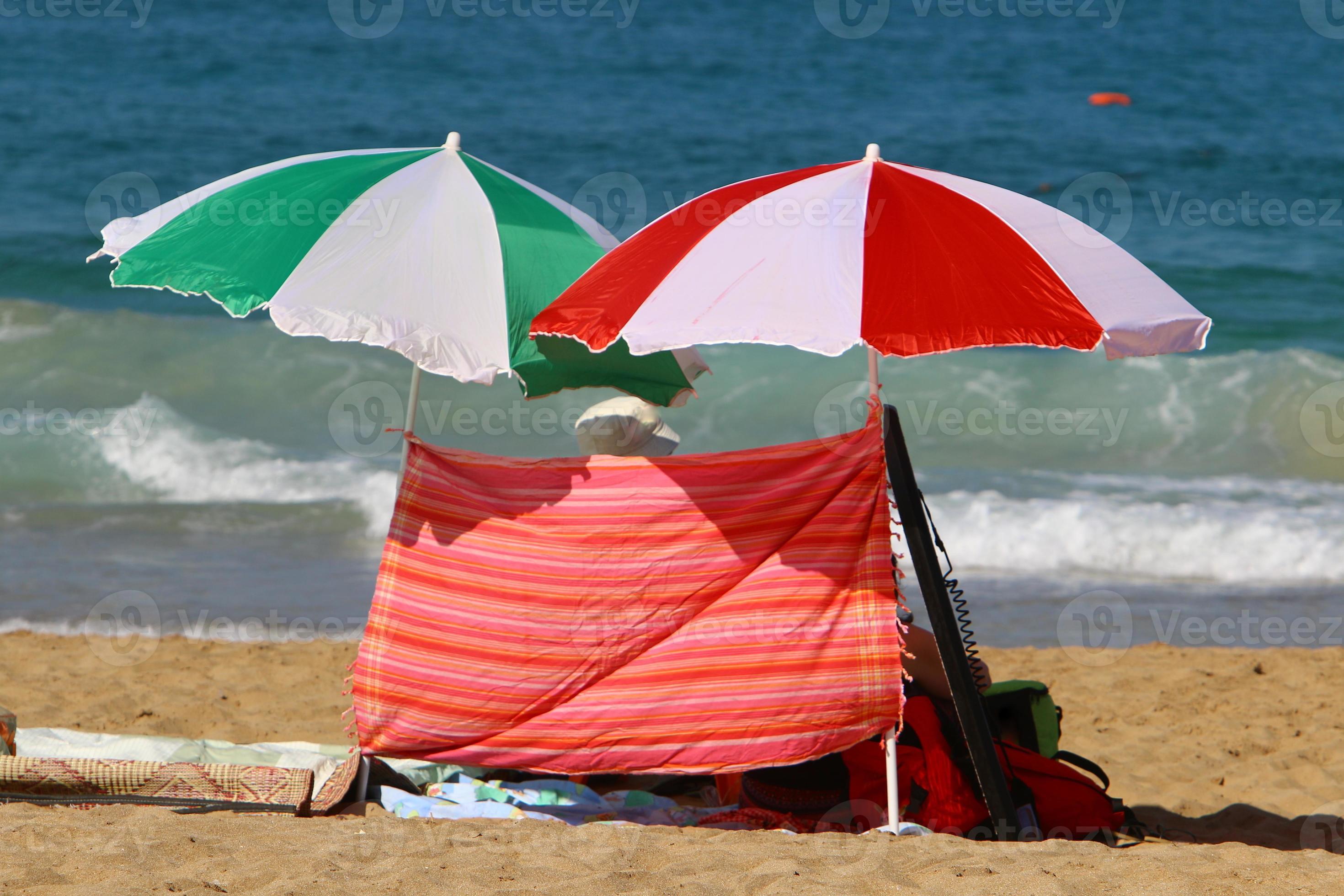 Umbrella for shelter from the sun on the city beach. 10012059 Stock