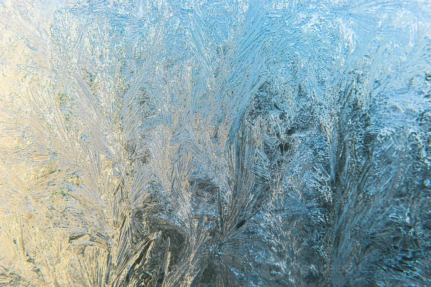 Frozen winter window with shiny ice frost pattern texture. Christmas wonder symbol, abstract background. Extreme north low temperature, natural Ice snow on frosty glass, cool winter weather outdoor. photo