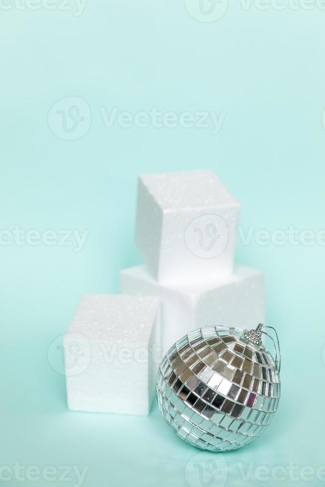 Simply minimal composition winter object ornament and cube shapes geometric form podium isolated blue pastel background. Christmas New Year december time for celebration concept. Mockup, copy space photo