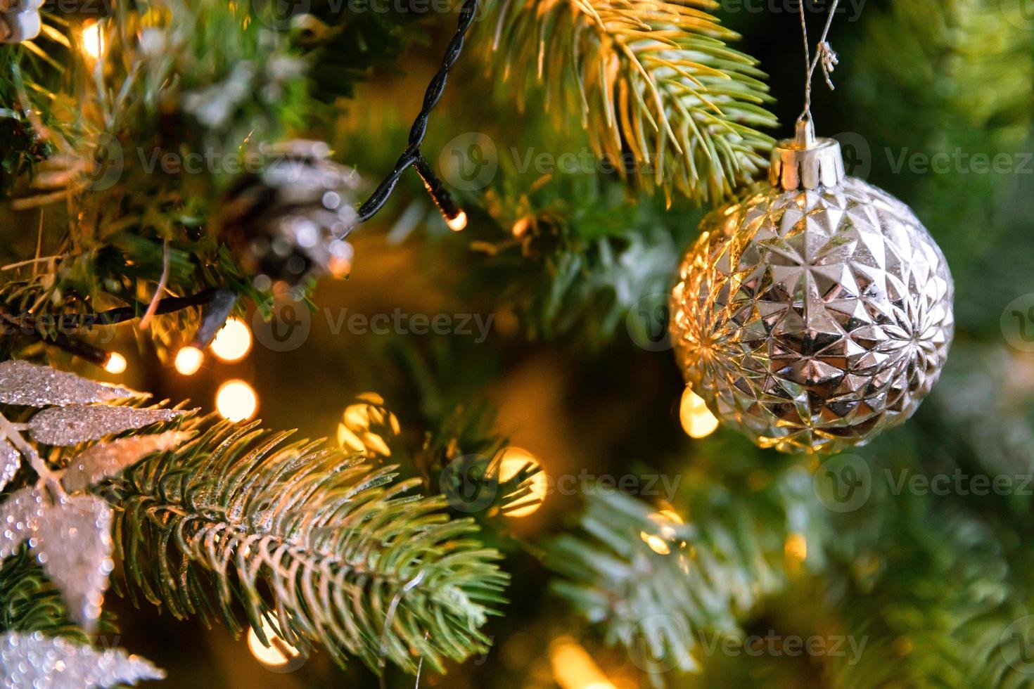 Classic Christmas decorated New year tree. Christmas tree with wite and silver decorations, ornaments toy and ball. Modern classical style interior design apartment. Christmas eve at home. photo