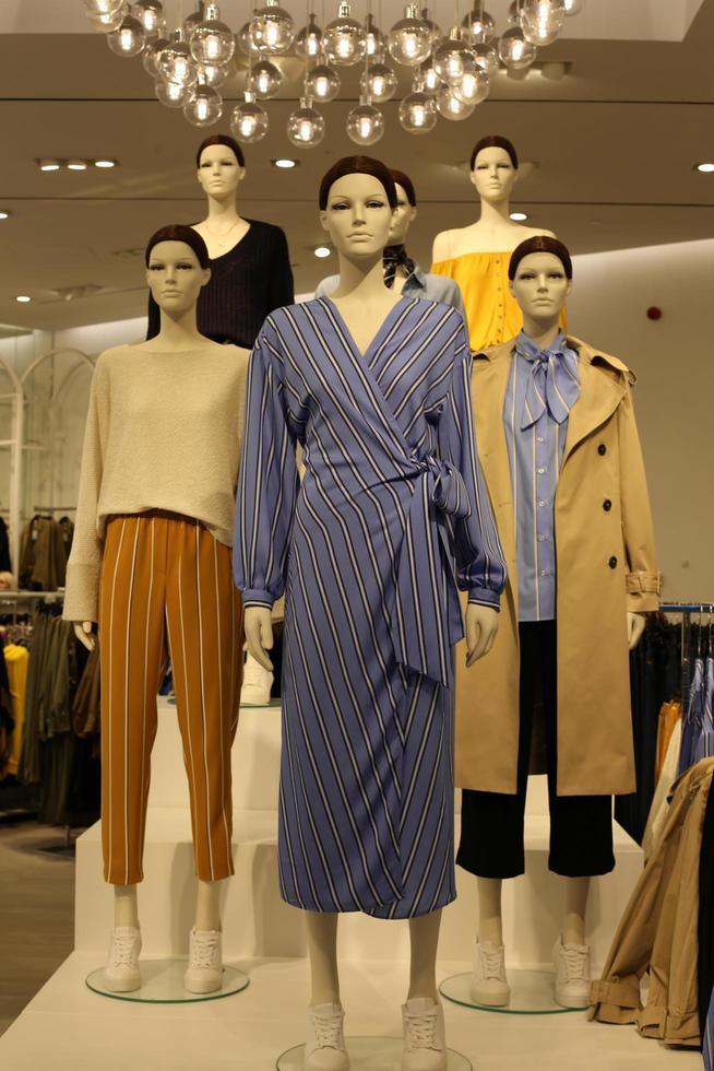 A mannequin stands on a showcase in a store. photo