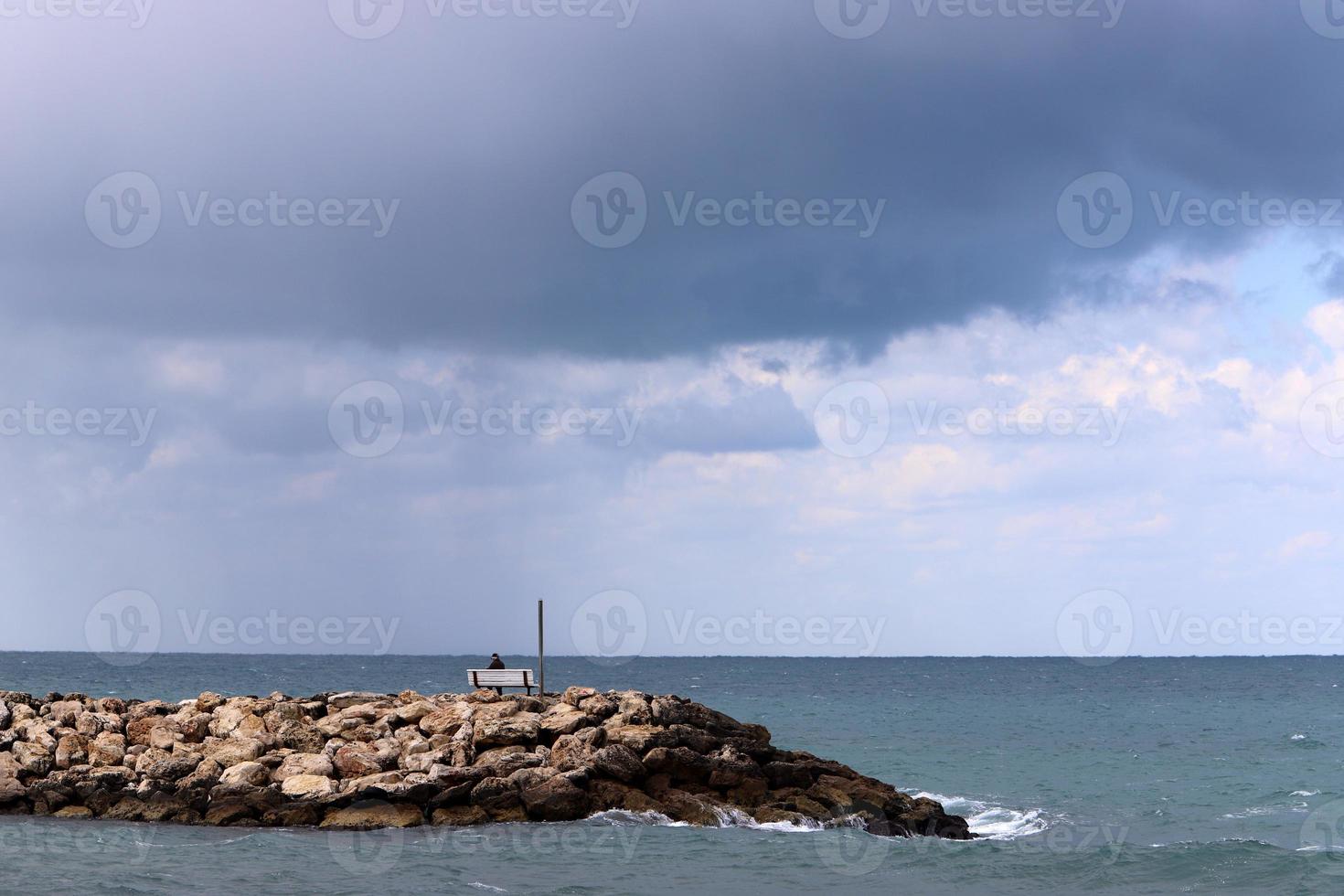 Breakwater on the city beach for protection from high sea waves. photo