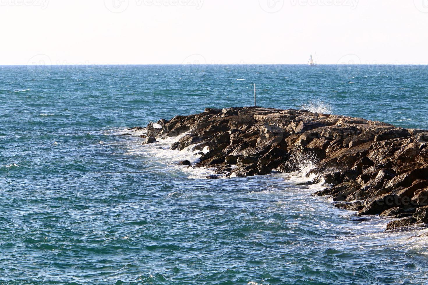 Breakwater on the city beach for protection from high sea waves. photo