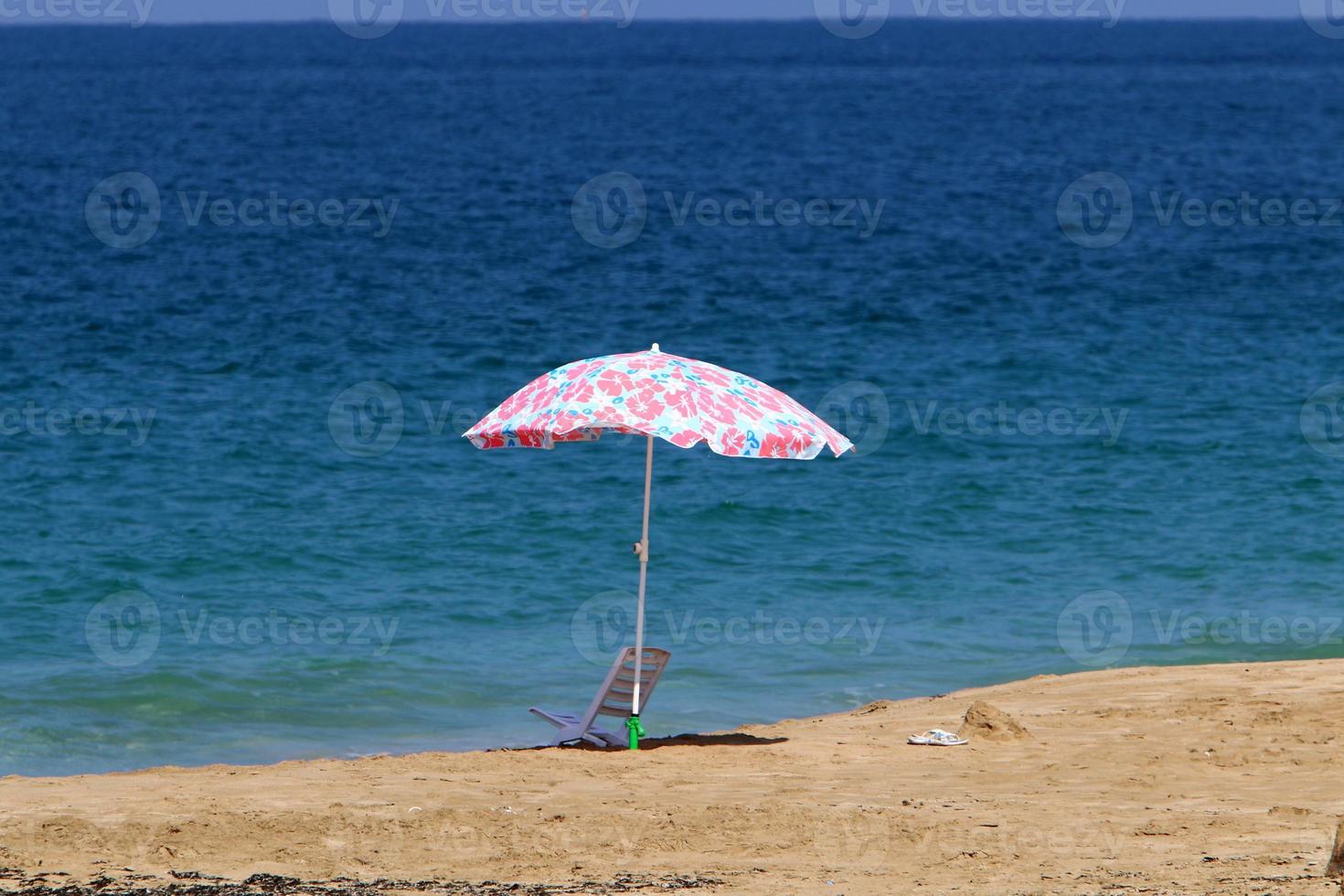 Umbrella for shelter from the sun on the city beach. photo