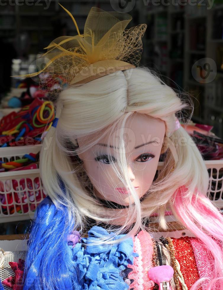 A mannequin stands on a showcase in a large store. photo