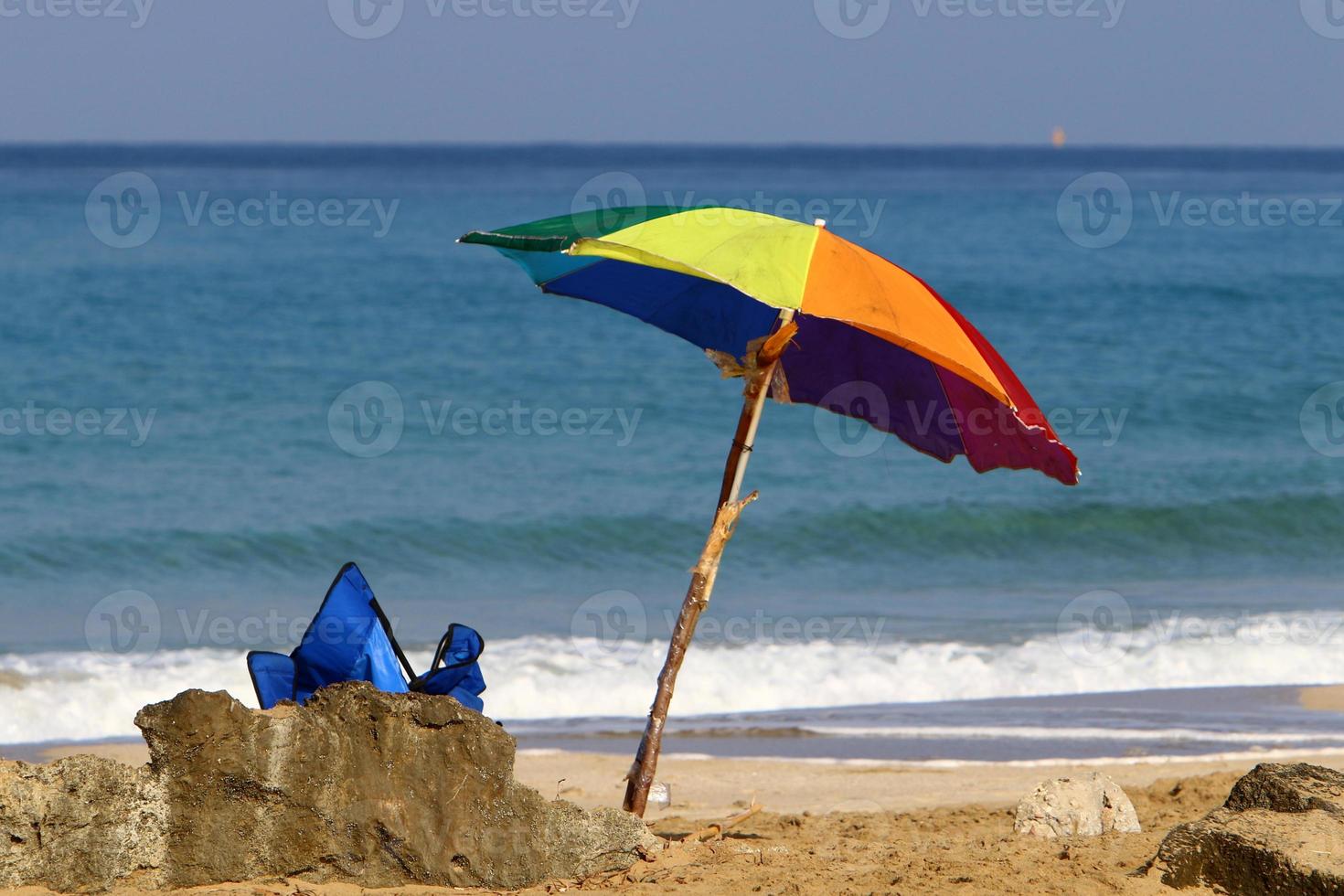 Umbrella for shelter from the sun on the city beach. photo