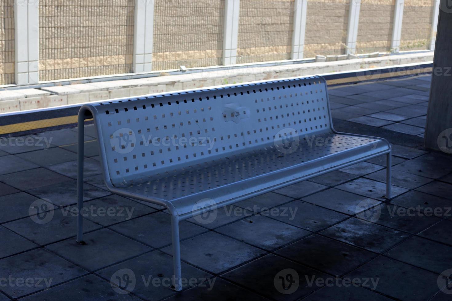 Bench for rest in the city park on the seashore. photo