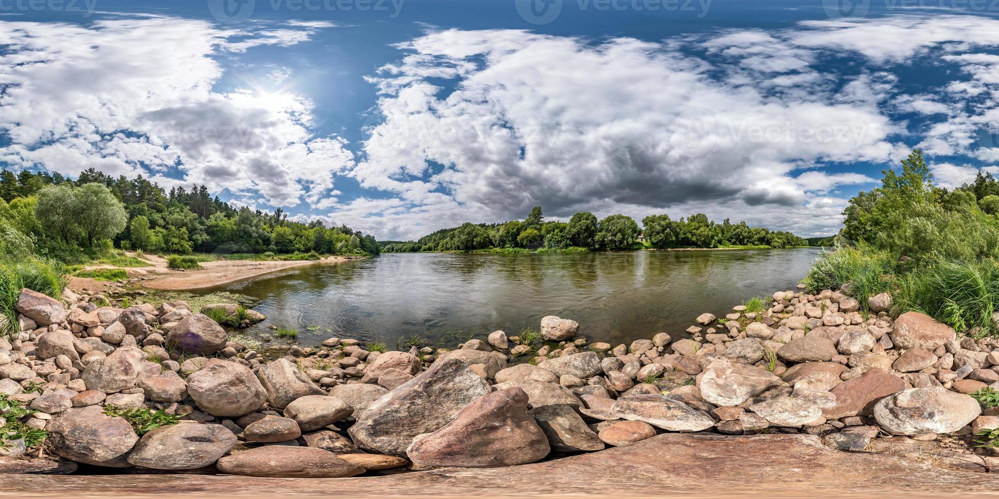 full spherical seamless hdri panorama 360 degrees angle view on rocky shore of huge river in sunny summer day and windy weather with beautiful clouds in equirectangular projection, VR content photo