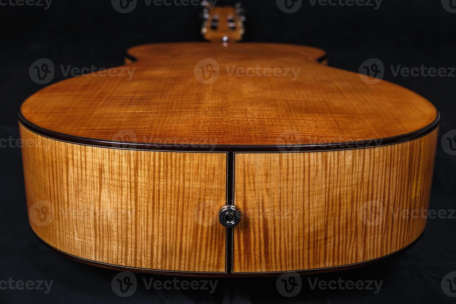 wood texture of lower deck of six strings acoustic guitar on black background photo