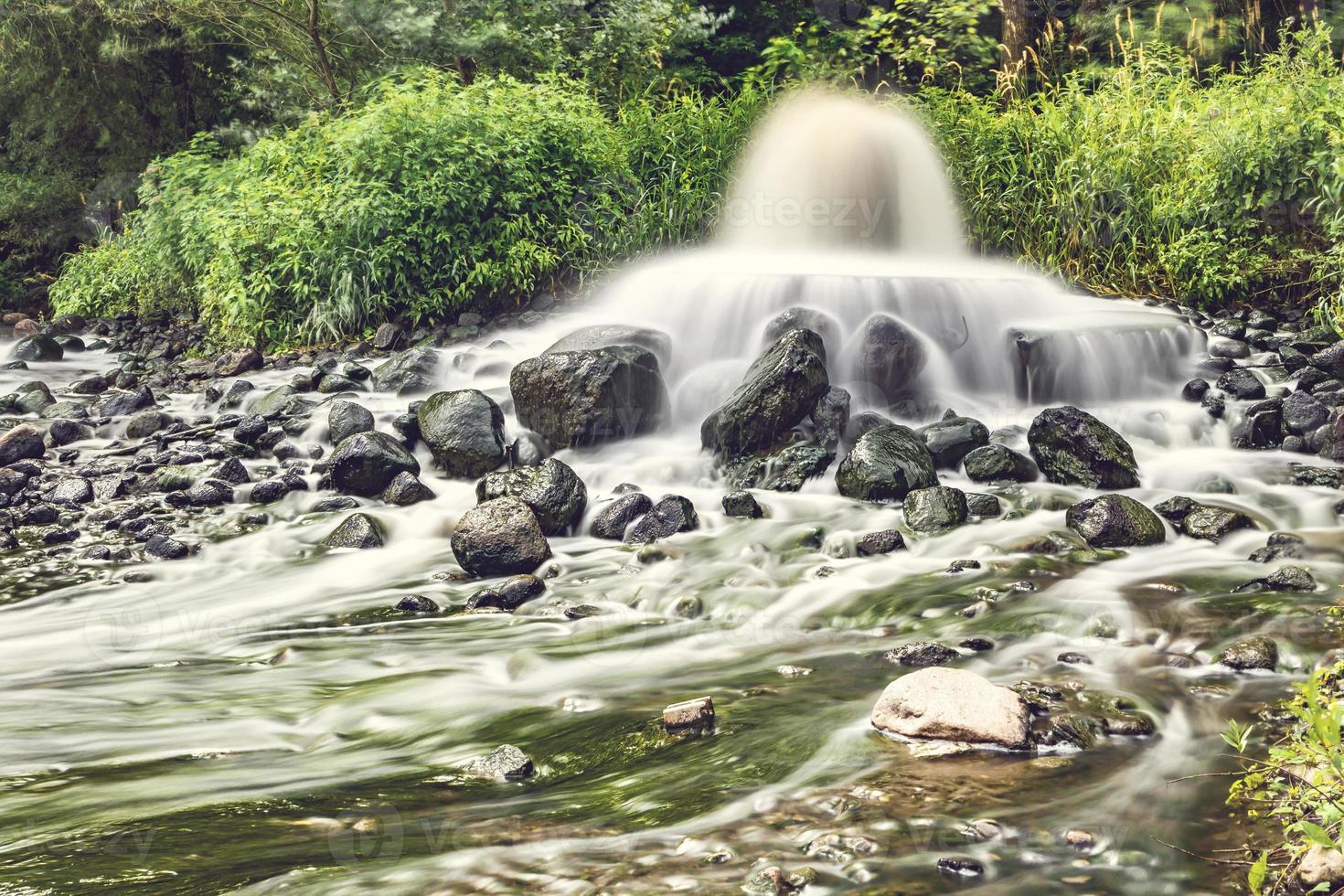 mixing zone of sewage discharge of urban sewage. river pollution. city dumps. artificial geyser. long exposure photo