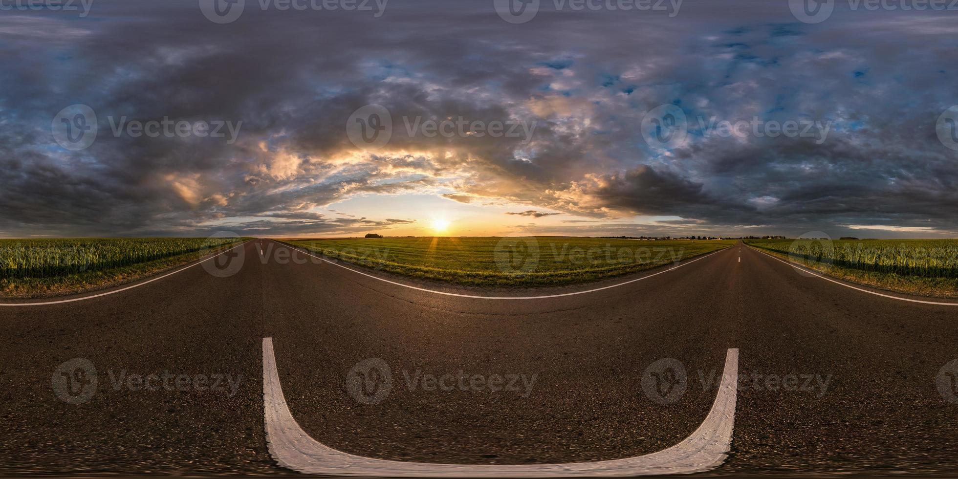 full spherical seamless hdri panorama 360 degrees angle view on asphalt road among fields in summer evening sunset with awesome clouds in equirectangular projection, for VR AR virtual reality content photo