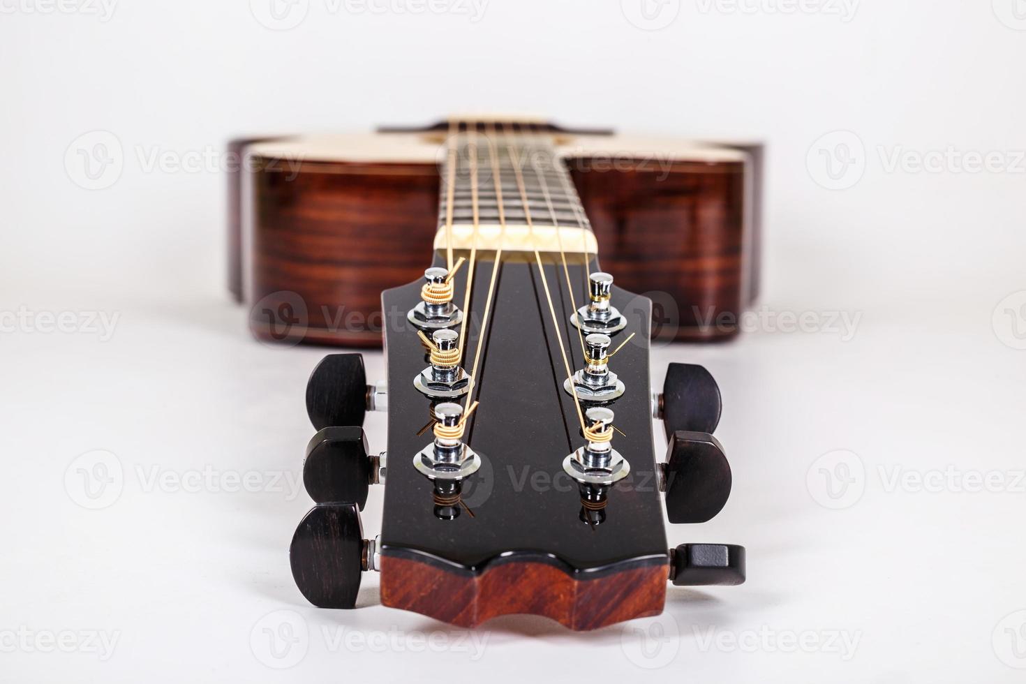 Tuning pegs on wooden machine head of six strings guitar on white background photo