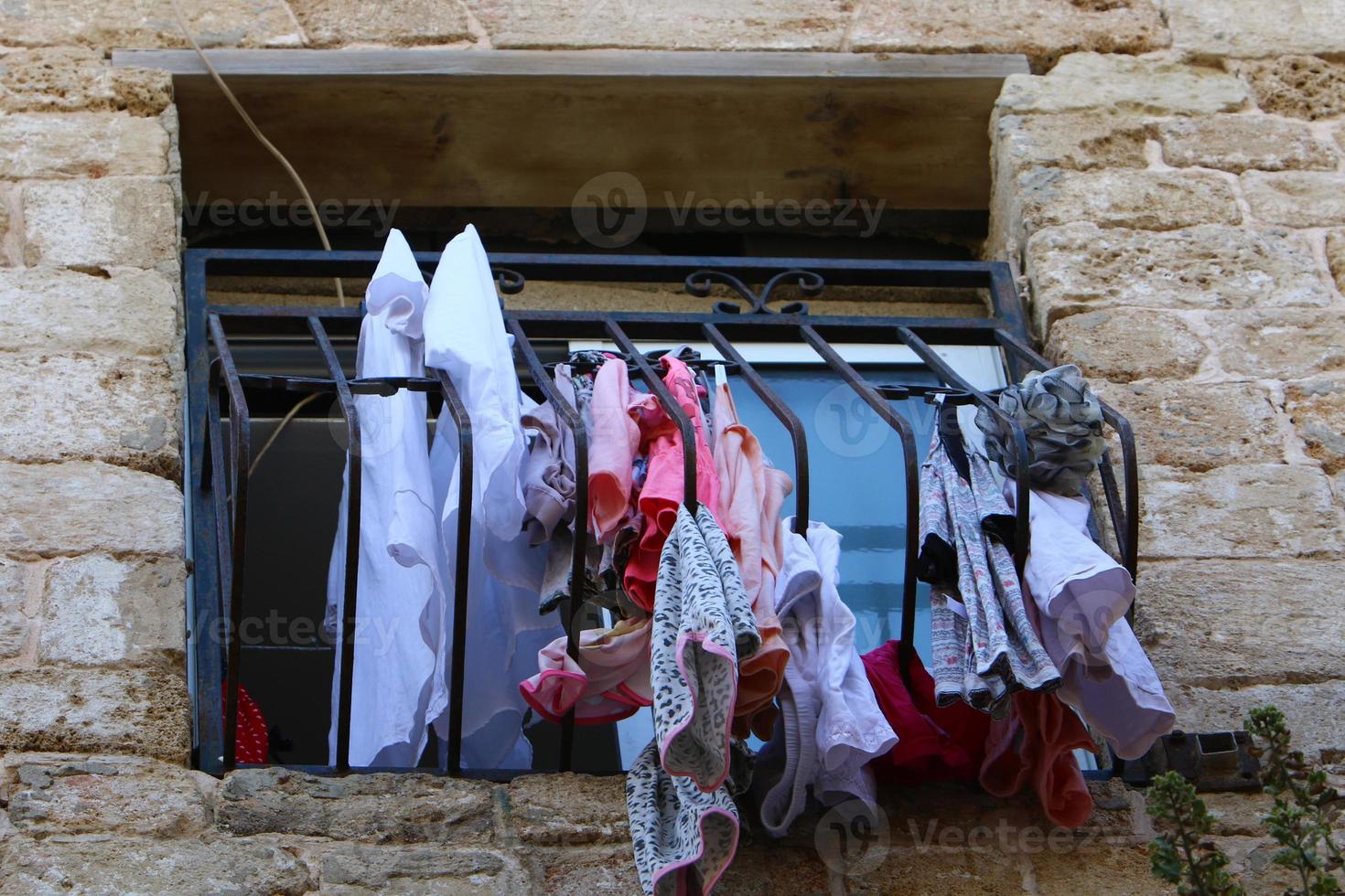 Outside the window, laundry is being dried on a rope on the facade of the building. photo