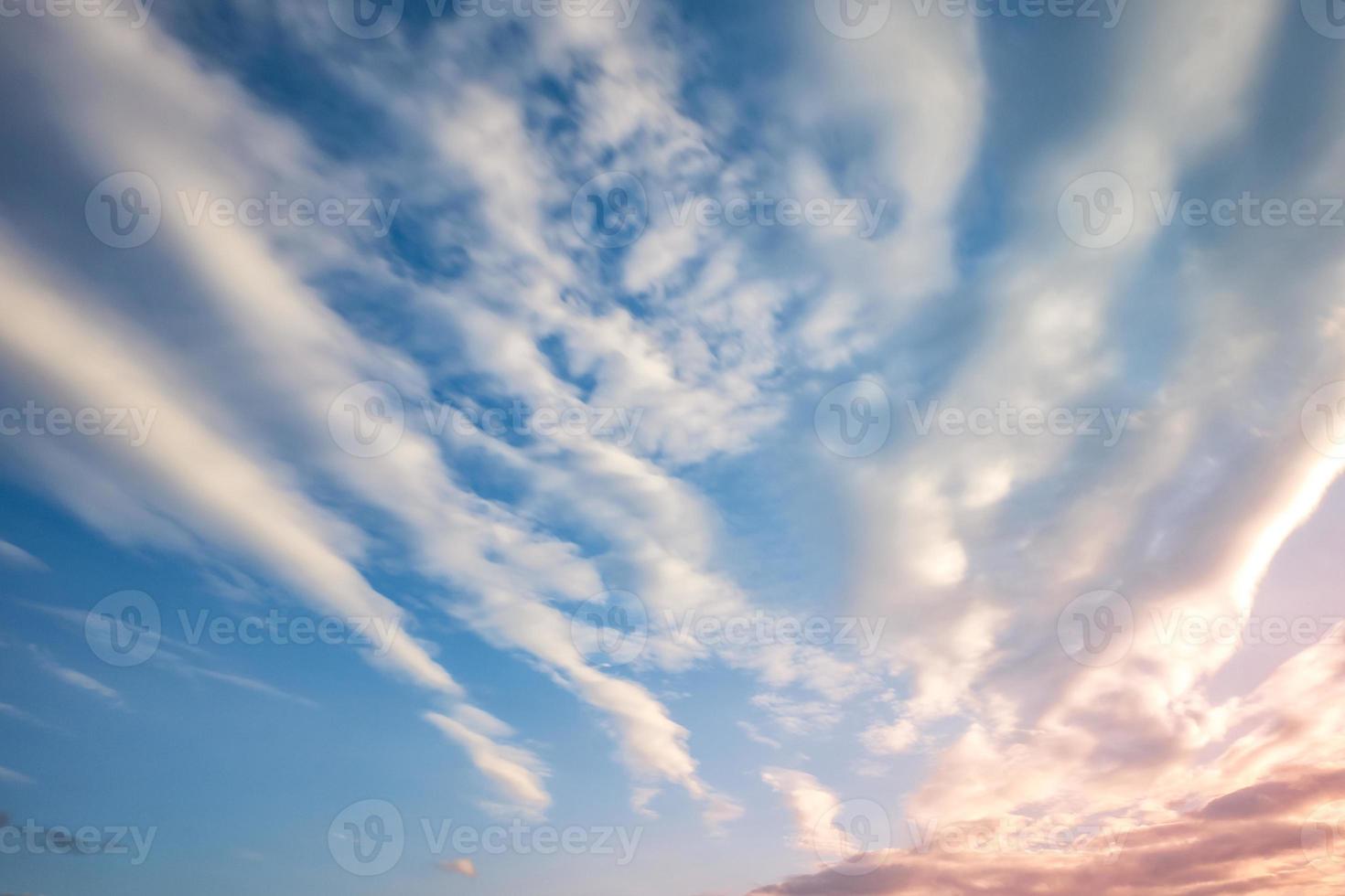 Blue sky background with tiny curly striped clouds in the evening. Clearing day and Good windy weather photo