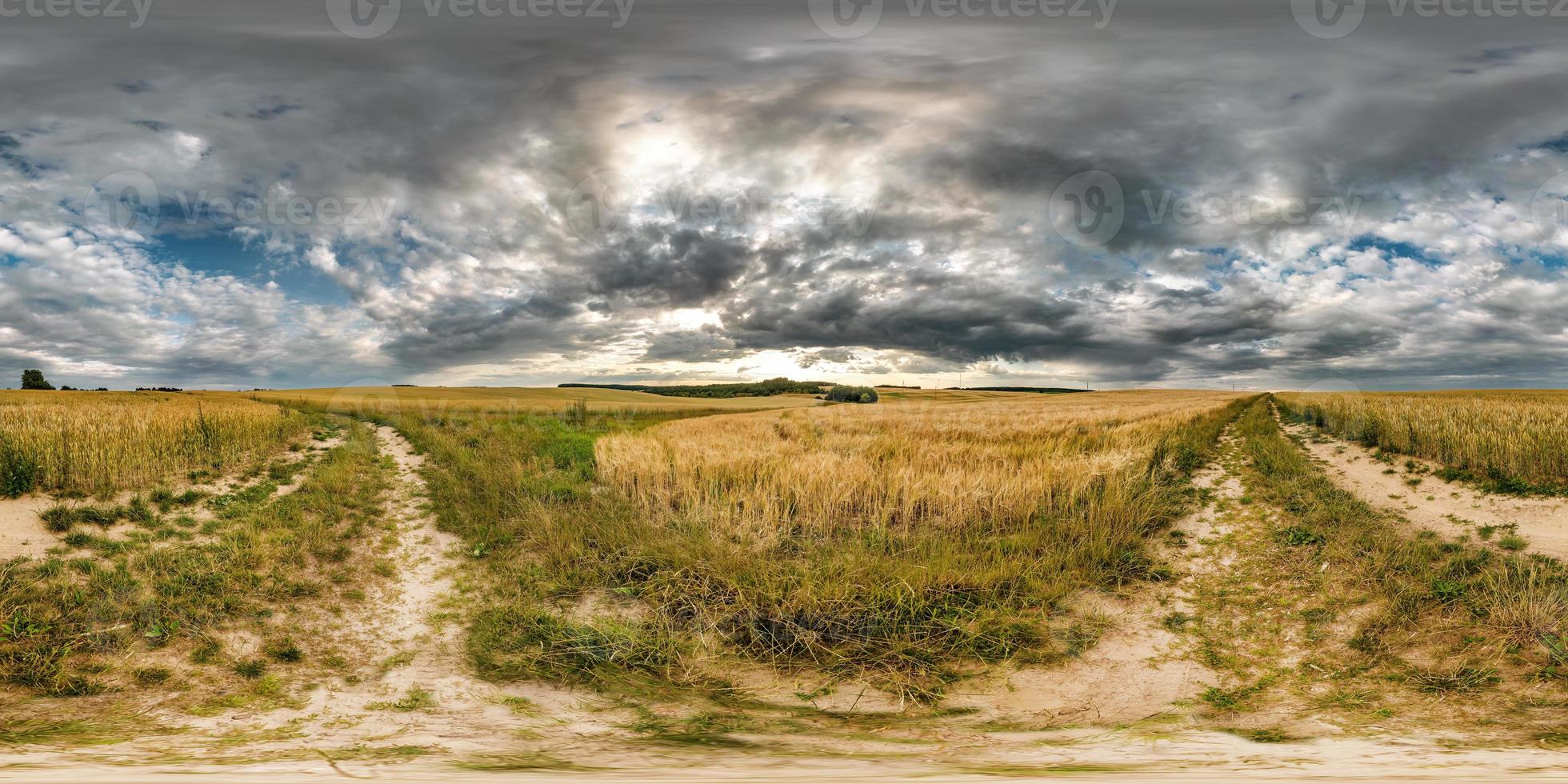 full seamless spherical hdri panorama 360 degrees angle view on gravel road among fields in summer evening with awesome clouds in equirectangular projection, ready for VR AR virtual reality content photo
