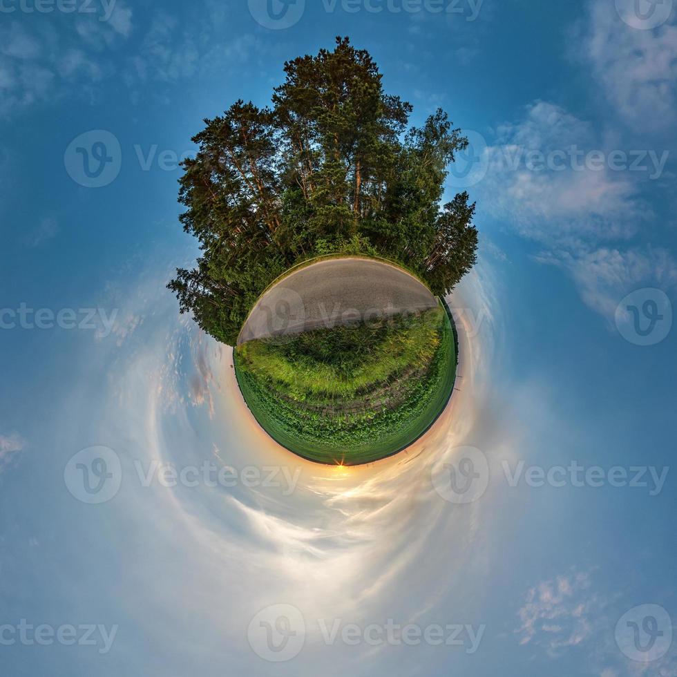 Little planet transformation of spherical panorama 360 degrees. Spherical abstract aerial view in field in nice evening with awesome beautiful clouds. Curvature of space. photo