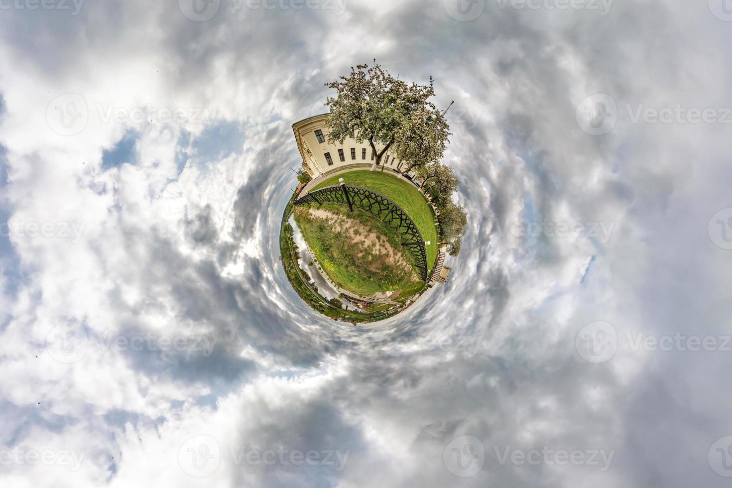 Little planet transformation of spherical panorama 360 degrees. Spherical abstract aerial view in field in nice evening with awesome beautiful clouds. Curvature of space. photo
