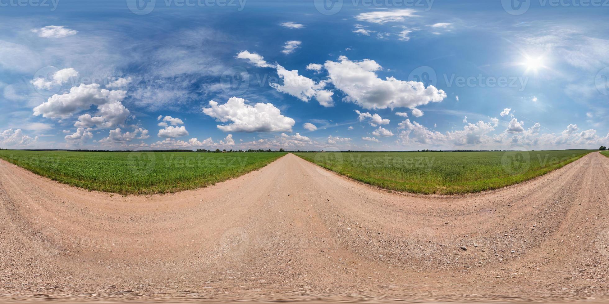 full seamless spherical hdri panorama 360 degrees angle view on gravel road among fields in summer day with awesome clouds before storm in equirectangular projection, for VR AR virtual reality content photo
