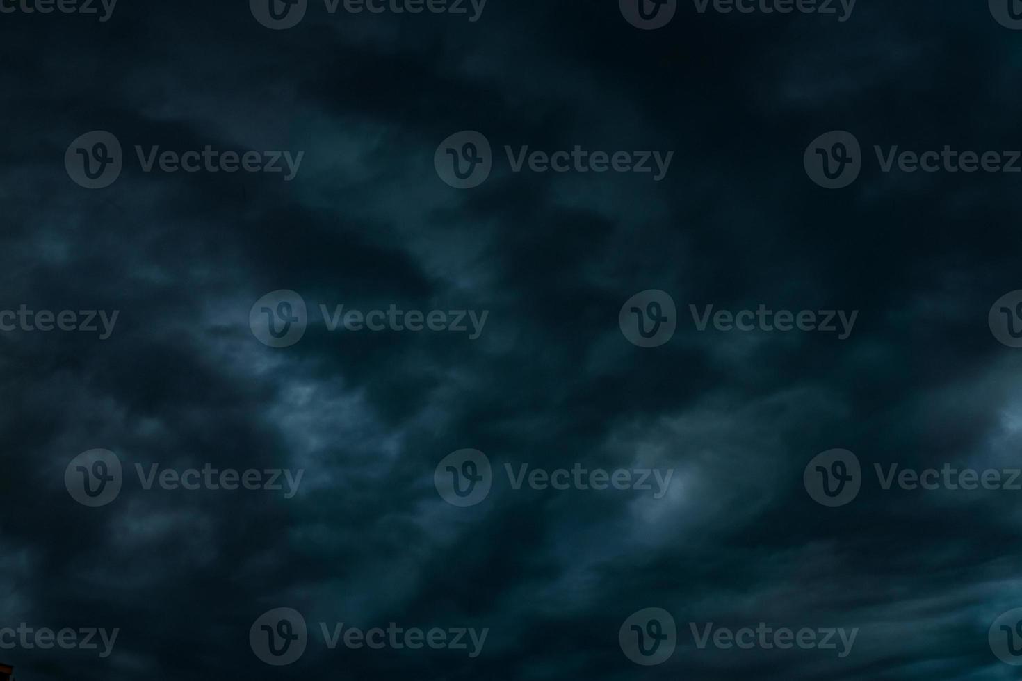 dark Blue sky background with evening fluffy curly rolling altocumulus altostratus clouds photo