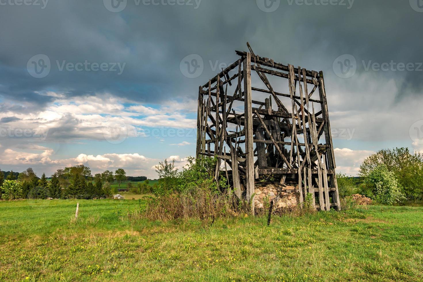 remains of old burnt windmill in the field before the rain photo