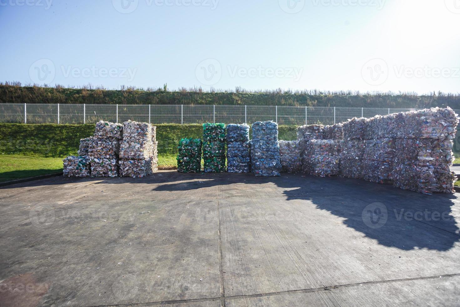 Plastic bales at the waste processing plant. Separate garbage collection. Recycling and storage of waste for further disposal. Business for sorting and processing of waste. photo