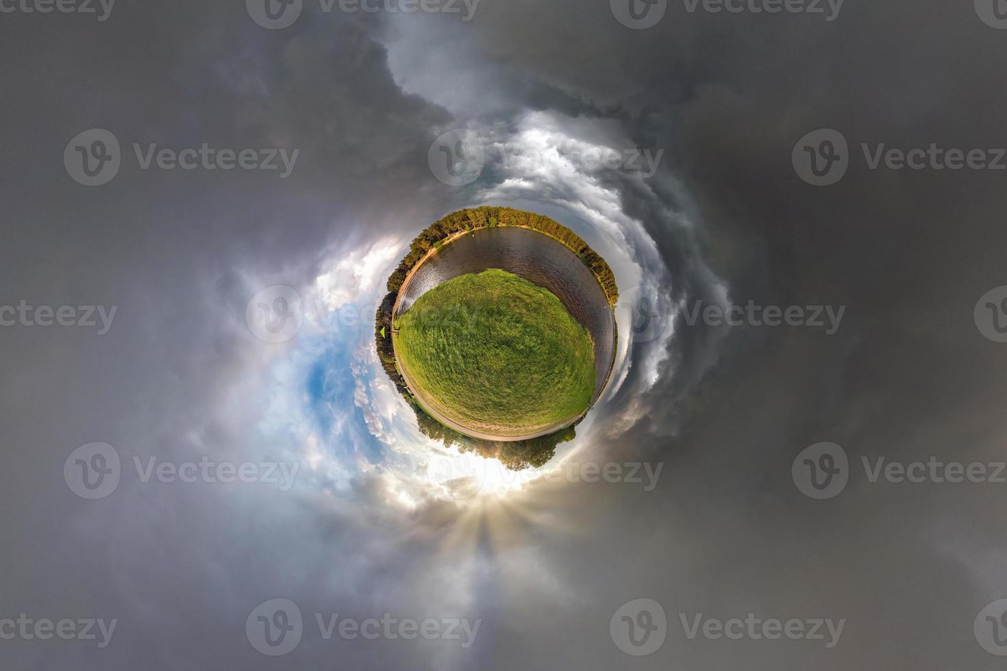 Little planet transformation of spherical panorama 360 degrees. Spherical abstract aerial view in field in nice evening with awesome beautiful clouds. Curvature of space. photo