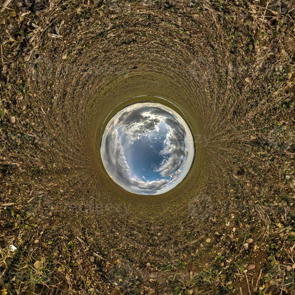 blue sky ball in middle of swirling field. Inversion of tiny planet transformation of spherical panorama 360 degrees. Curvature of space. photo